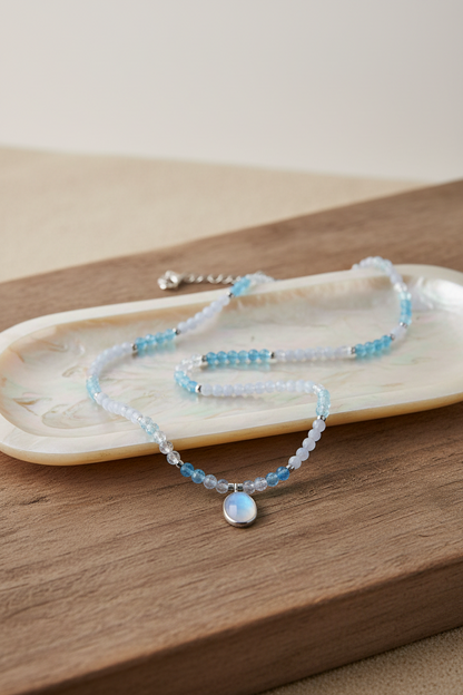 Colar Duna Tündöklés da Körössy — joia em prata 925 com água-marinha, ágata blue lace e pingente de pedra da lua, feito à mão.